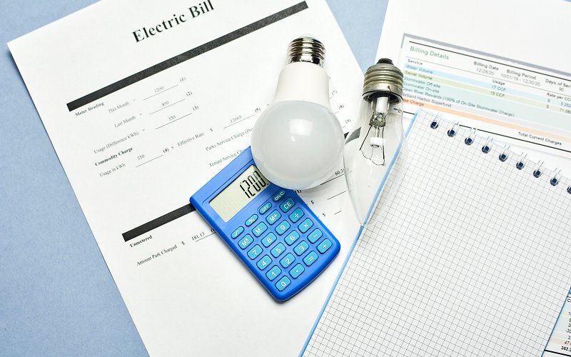Calculator and light bulbs placed on an electric bill.